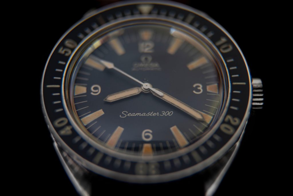 Rare vintage Omega Seamaster 300 diver wristwatch on black background